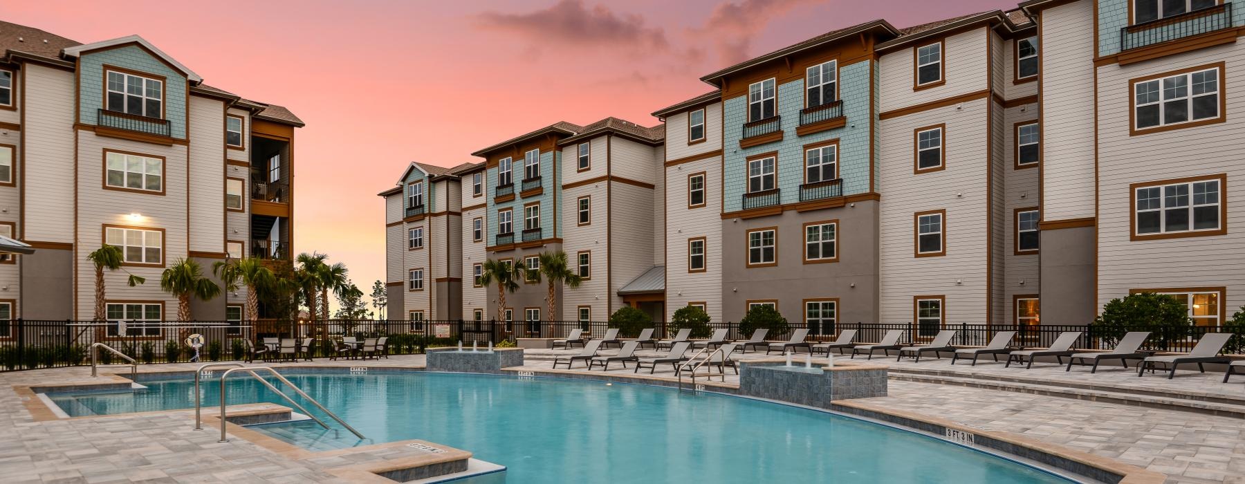 a swimming pool with buildings behind it